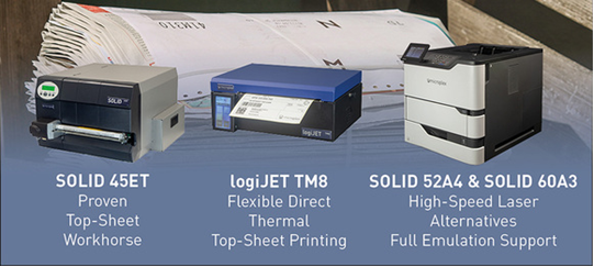 Microplex SOLID 45ET, logiJET TM8 och SOLID 52A4 framför en bunt tidningar